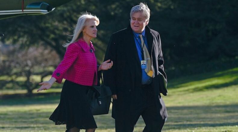 White House counselor Kellyanne Conway, left, and senior adviser Steve Bannon, right, walk on the South Lawn of the White House in Washington, Thursday, Jan. 26, 2017, after returning via Marine One from a trip to Philadelphia with President Donald Trump. (AP Photo/Susan Walsh)