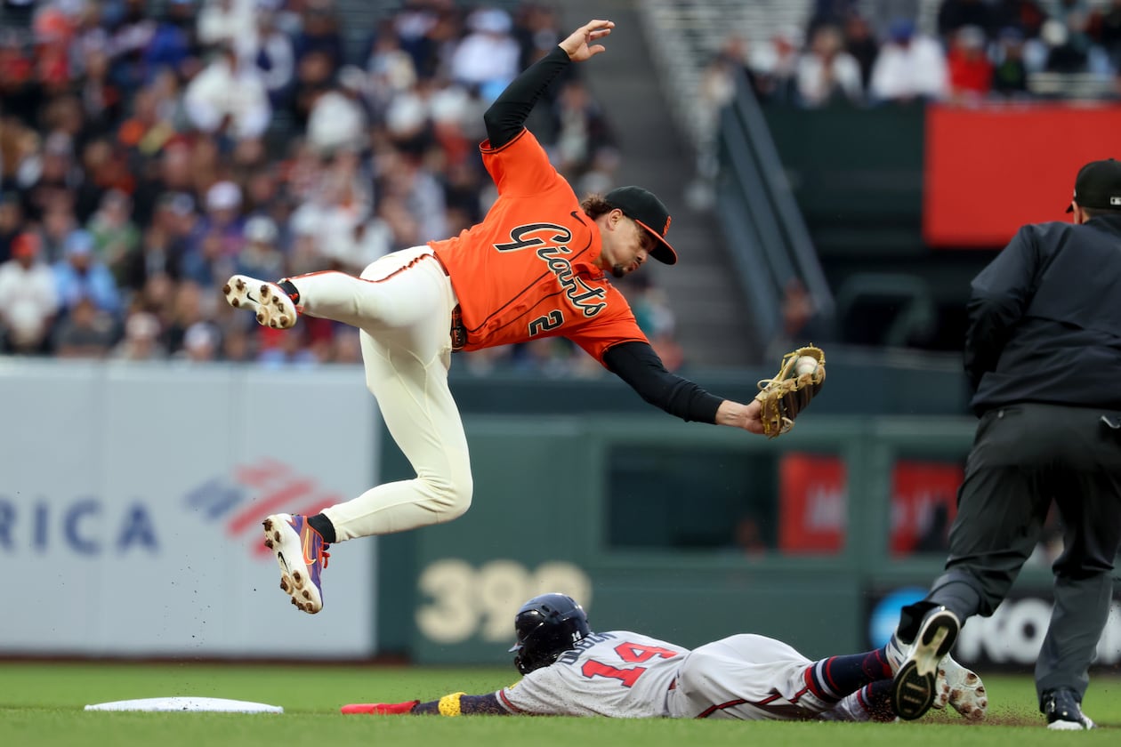 Atlanta Braves' Mauricio Dubón (on the ground) steals second base as San Francisco Giants shortstop Willy Adames fields the throw during the first inning of a baseball game in San Francisco, Friday, June 26, 2026. (Jed Jacobsohn/AP)