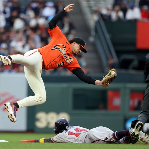 Atlanta Braves' Mauricio Dubón (on the ground) steals second base as San Francisco Giants shortstop Willy Adames fields the throw during the first inning of a baseball game in San Francisco, Friday, June 26, 2026. (Jed Jacobsohn/AP)