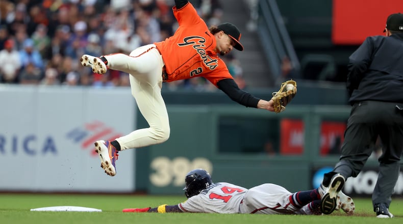 Atlanta Braves' Mauricio Dubón (on the ground) steals second base as San Francisco Giants shortstop Willy Adames fields the throw during the first inning of a baseball game in San Francisco, Friday, June 26, 2026. (Jed Jacobsohn/AP)