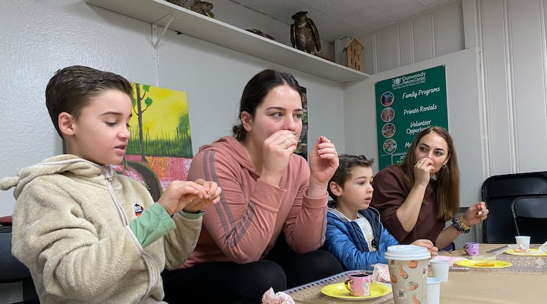 Dunwoody Nature Center's "Bees, Teas and Honey" program kicked off Jan. 12. The participants are shown creating fresh teas from mint and roses experiencing different smells, textures and flavors. (L-R: Liam Randall, Alessandra Pizzorni, Aiden Randall, Maja Randall).