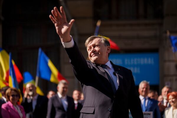 FILE - Crin Antonescu, presidential candidate for the ruling coalition, made of the Social Democratic Party (PSD), the Liberal Party (PNL) and the Democratic Alliance of Hungarians in Romania (UDMR), waves after registering his bid with the electoral authority in Bucharest, Romania, Sunday, March 9, 2025. (AP Photo/Vadim Ghirda, File)