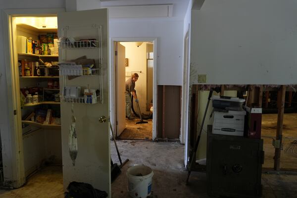Volunteer Cameron Carpenter helps clean up a house after flooding in Kerrville, Texas on Tuesday, July 8, 2025. (AP Photo/Ashley Landis)