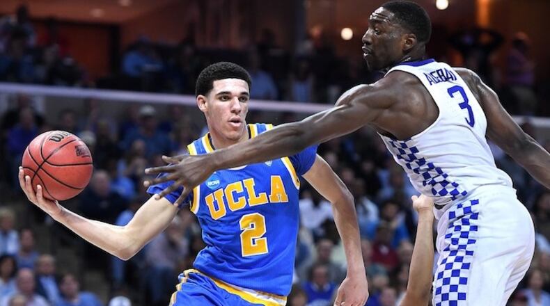 UCLA's Lonzo Ball (2) gets a pass off in front of Kentucky's Isaiah Briscoe, middle, and Edrice Adebayo in the second half during an NCAA Tournament South Regional semifinal on Friday, March 24, 2017 at FedExForum in Memphis, Tenn. Kentucky advanced, 86-75. (Wally Skalij/Los Angeles Times/TNS)