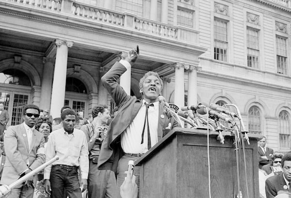 FILE - Bayard Rustin, civil rights organizer, speaks from a platform erected in front of New York's City Hall, May 18, 1964, as a crowd of some 3,000 persons rallied that was high point of day-long activities by civil rights groups seeking school integration. (AP Photo, File)