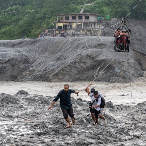 Residents pull a newly installed zipline to help people commute across the Trishuli river in the aftermath of flash floods at Bidur in Nepal's Nuwakot district, Nepal, Wednesday, Sept. 2, 2026. (AP Photo/Rajesh Kumar Singh)