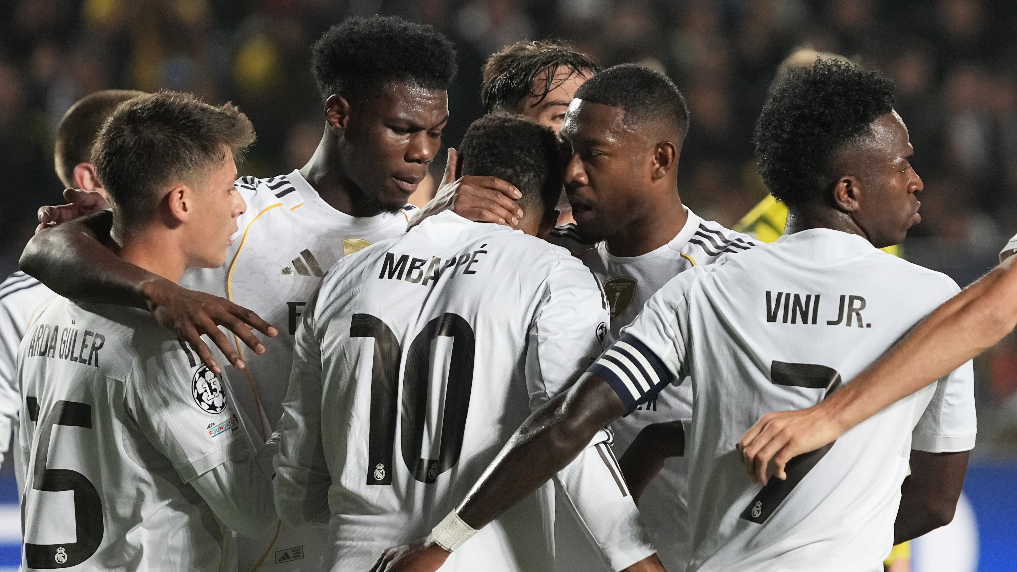 Real Madrid's players celebrate their side's first goal scored by Kylian Mbappe, center, from the penalty spot during the Champions League opening phase soccer match between Kairat Almaty and Real Madrid at the Ortalyk stadium in Almaty, Kazakhstan, Tuesday, Sept. 30, 2025. (AP Photo/Turar Kazangapov)