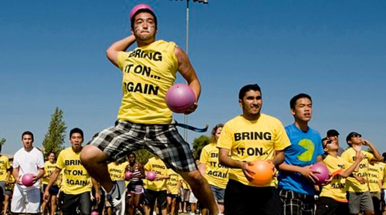 Sean Ellis, 19, goes airborne as he fires a ball at the blue team .