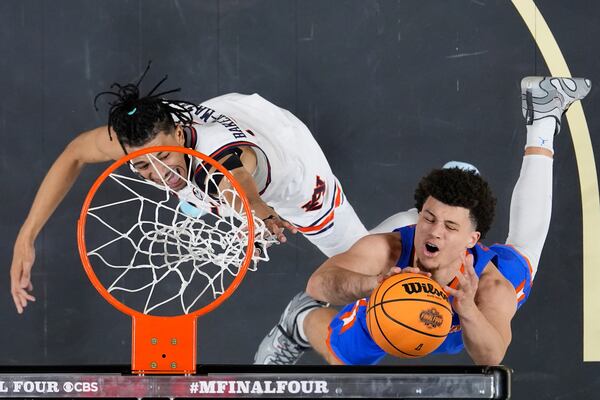 Auburn guard Chad Baker-Mazara vies for the ball with Florida guard Walter Clayton Jr. during the first half in the national semifinals at the Final Four of the NCAA college basketball tournament, Saturday, April 5, 2025, in San Antonio. (AP Photo/Brynn Anderson)