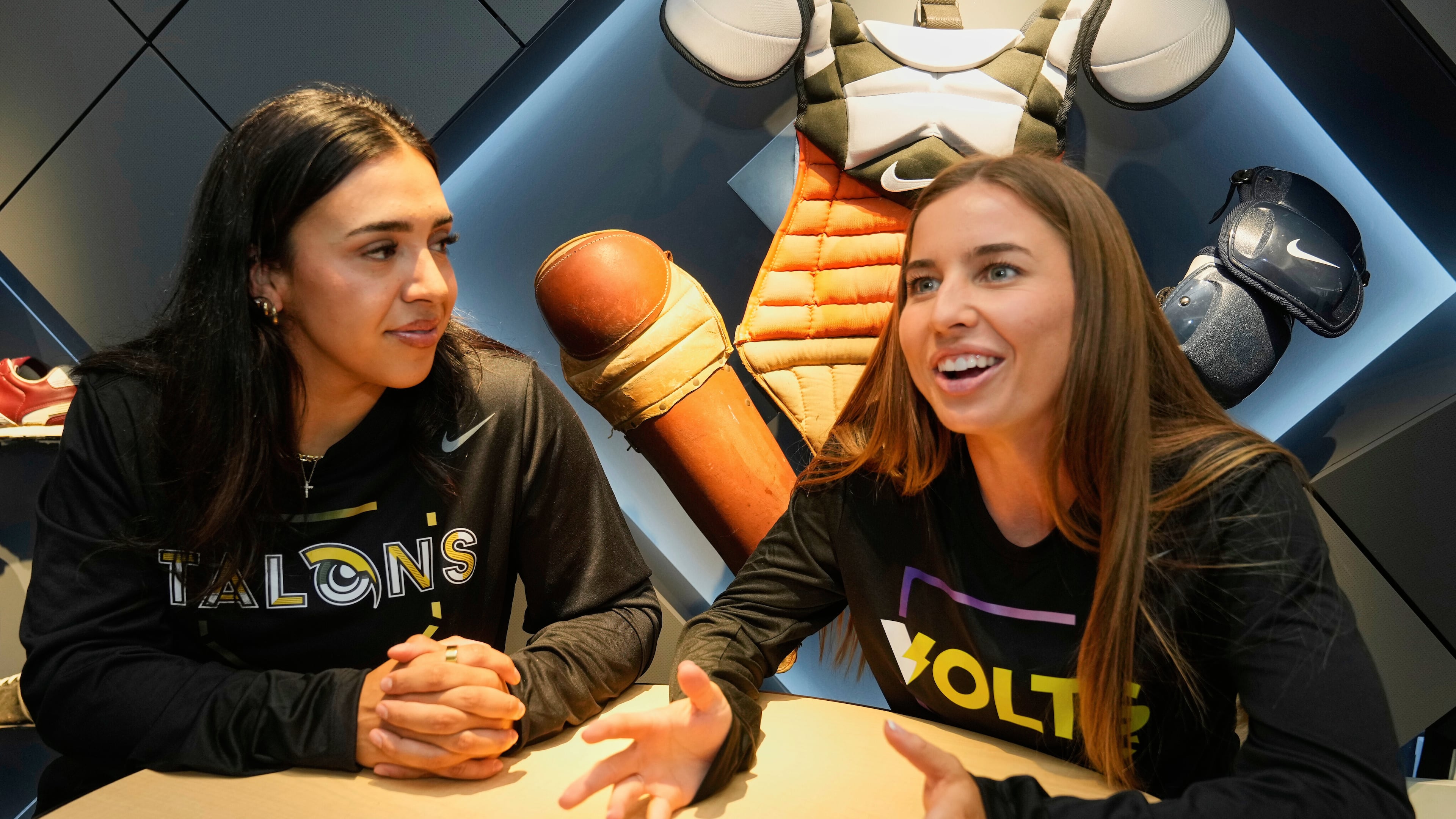 FILE - Athletes Unlimited Softball League players Sharlize Palacios, left, of the Talons, and Sis Bates of the Bolts, are interviewed at Major League Baseball's headquarters in New York, Thursday, May 29, 2025. (AP Photo/Richard Drew, File