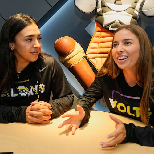 FILE - Athletes Unlimited Softball League players Sharlize Palacios, left, of the Talons, and Sis Bates of the Bolts, are interviewed at Major League Baseball's headquarters in New York, Thursday, May 29, 2025. (AP Photo/Richard Drew, File