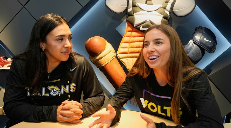 FILE - Athletes Unlimited Softball League players Sharlize Palacios, left, of the Talons, and Sis Bates of the Bolts, are interviewed at Major League Baseball's headquarters in New York, Thursday, May 29, 2025. (AP Photo/Richard Drew, File