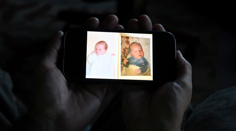 Jeremy Morrison, who says he was sent home with the wrong parents after he was born, shows what he believes is a baby photo of him, left, and of the other baby he says was switched at birth while recounting the story at his home in Colorado City, Colo., on Thursday, July 16, 2026. (AP Photo/Thomas Peipert)