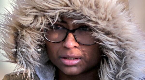 Prachi Sahoo walks in the 1000 block of Howell Mill in the chill Thursday morning.