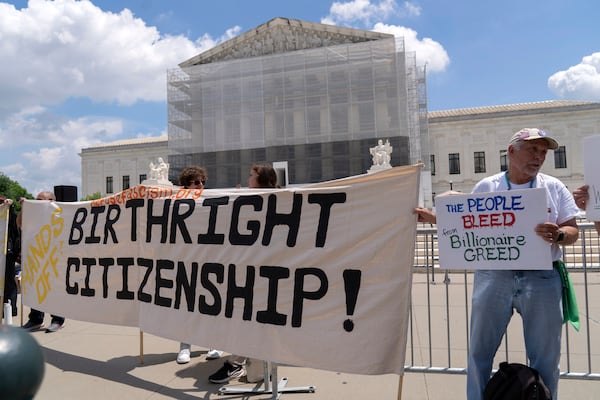 Demonstrators recently held banners and signs  during a citizenship rally outside of the U.S. Supreme Court in Washington.