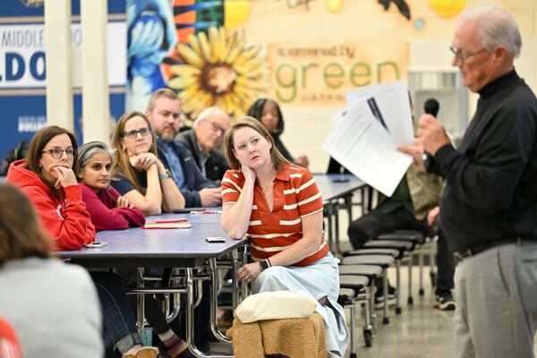 James Wilson (right), with consulting firm Education Planners, started Thursday's community meeting with an apology to Decatur parents who didn't receive an email about the event because of a technical glitch. (Daniel Varnado for the AJC)