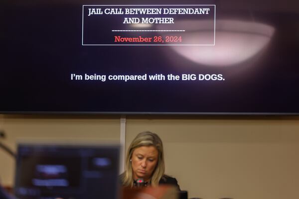 A screen shows a text saying “I’m being compared with the big dogs” from a recorded detention center call between Colt Gray, the 16-year-old Apalachee High School shooter, and his mother Marcee during his sentencing hearing. Also pictured is Ashley Gilland, investigator for the Barrow County District Attorney's office. (Arvin Temkar/AJC)