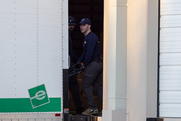 An FBI agent brings boxes of evidence into a truck at the Fulton County Election Hub and Operation Center in Union City on Wednesday, Jan. 28, 2026. A team of agents scoured the building over the course of several hours. (Arvin Temkar/AJC)