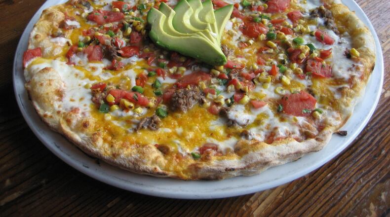 The spicy Mayan pizza at Fire Stone Wood Fired Pizza & Grill in Woodstock offers south of the border flavors like a poblano salsa, smoked shredded beef and corn pico. Photo: Fire Stone Wood Fired Pizza & Grill.