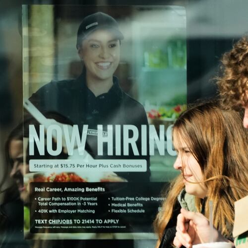 A hiring sign is displayed at a restaurant, in Niles, Ill., Tuesday, April 7, 2026. (AP Photo/Nam Y. Huh)