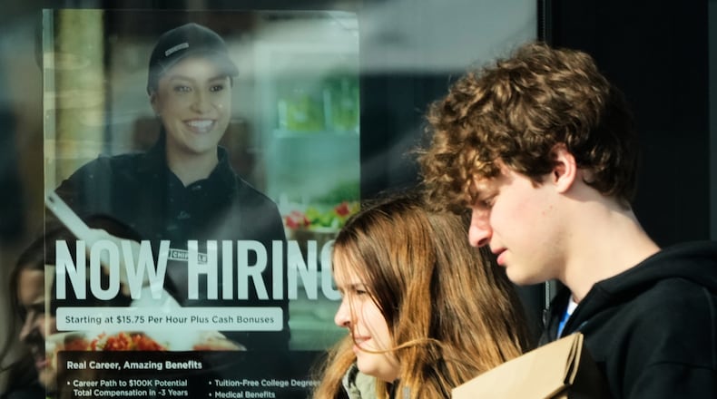 A hiring sign is displayed at a restaurant, in Niles, Ill., Tuesday, April 7, 2026. (AP Photo/Nam Y. Huh)