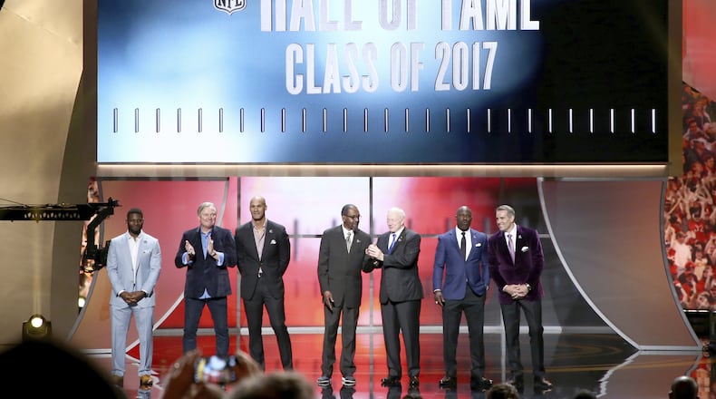 Former NFL players LaDainian Tomlinson, from the left, Morten Andersen, Jason Taylor, Kenny Easley, Jerry Jones, Terrell Davis and Kurt Warner are announced as inductees into the Pro Football Hall of Fame at the 6th annual NFL Honors at the Wortham Center on Saturday, Feb. 4, 2017, in Houston. (Photo by John Salangsang/Invision for NFL via AP)