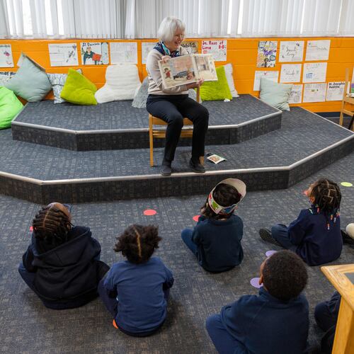 Rosemary Schleicher reads a book to a group of pre-k and Kindergarten students in the Saint Peter Claver Regional Catholic School library. Volunteers with the nonprofit Christ Child Society help needy children in several ways. At Saint Peter Claver Regional Catholic School they tutor and support the students and staff. (Phil Skinner for the AJC)
