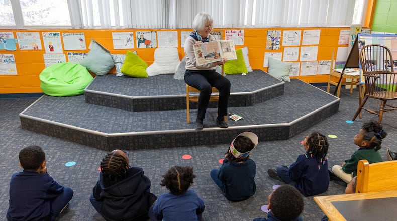 Rosemary Schleicher reads a book to a group of pre-k and Kindergarten students in the Saint Peter Claver Regional Catholic School library. Volunteers with the nonprofit Christ Child Society help needy children in several ways. At Saint Peter Claver Regional Catholic School they tutor and support the students and staff. (Phil Skinner for the AJC)