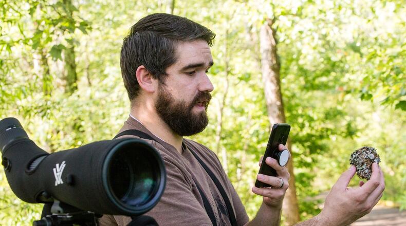 Adam Betuel of the Atlanta Audubon Society talks about a blue-gray gnatcatcher nest found during his birding walk at Constitution Lakes Park. During his walk Betuel broadcast his discoveries to birding enthusiasts by way of a Facebook Live streaming presentation. (Jenni Girtman for Atlanta Journal Constitution)