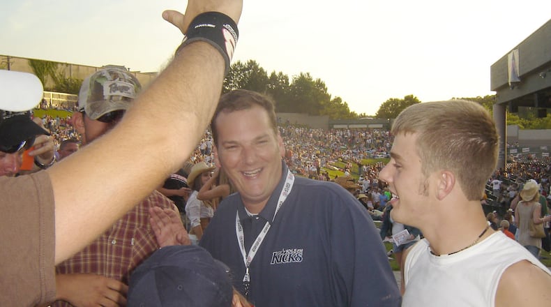 060519 ATLANTA, GA - New Kicks 101.5 morning host Cadillac Jack (center) hobnobs with fans including Kyle O'Kelley, 21, of Jackson, Ga. (right) at Country Fair 2006 Friday night. The sold-out two-day fair, held at HiFi Buys Amphitheatre, is sponsored by Kicks and Eagle 106.7 and featured Jason Aldean, Pat Green and Montgomery Gentry Friday. (Rodney Ho / AJC staff)
