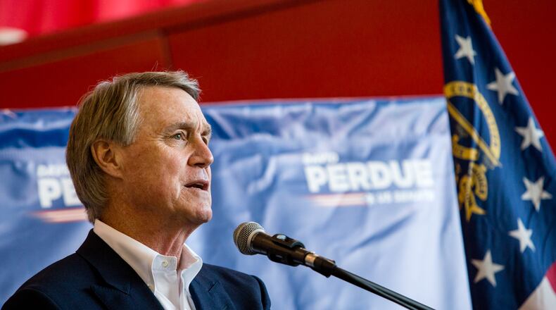 U.S. Sen. David Perdue holds a rally in November at Peachtree DeKalb Airport with South Carolina U.S. Sen. Tim Scott.  (Jenni Girtman for The Atlanta Journal-Constitution)