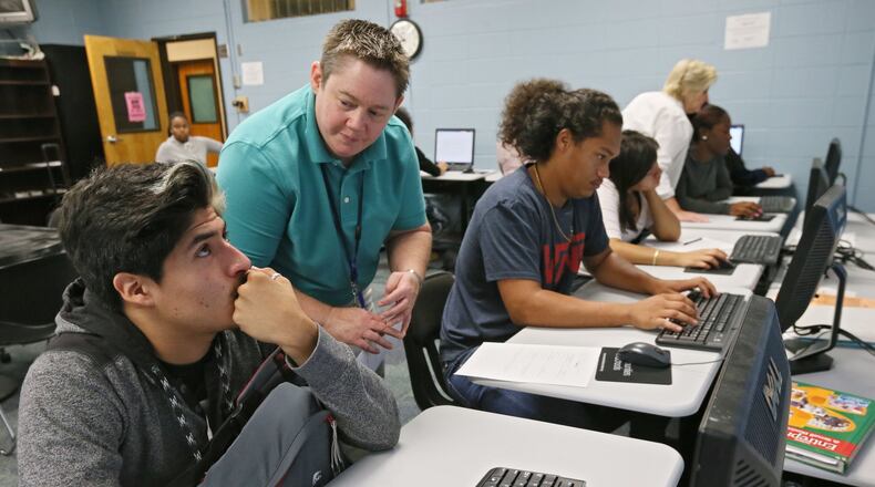 In this photo taken in September 2015, Cesar Gomez (left) gets some guidance from school counselor B.J. Smith as he works on his YouScience online assessment at the Marietta Performance Learning center. The Georgia Board of Education has approved a contract to make the career-aptitude test available in every high school. The data will let companies approach schools where students have attributes that match their needs, and offer internships, apprenticeships, job shadowing and other interactions that might set them on a career path they hadn’t considered BOB ANDRES / BANDRES@AJC.COM