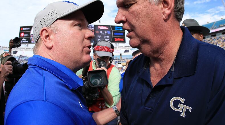 Head coaches Mark Stoops of the Kentucky Wildcats and Paul Johnson of the Georgia Tech Yellow Jackets shake hands after the game at EverBank Field on December 31, 2016 in Jacksonville, Florida. (Photo by Rob Foldy/Getty Images)