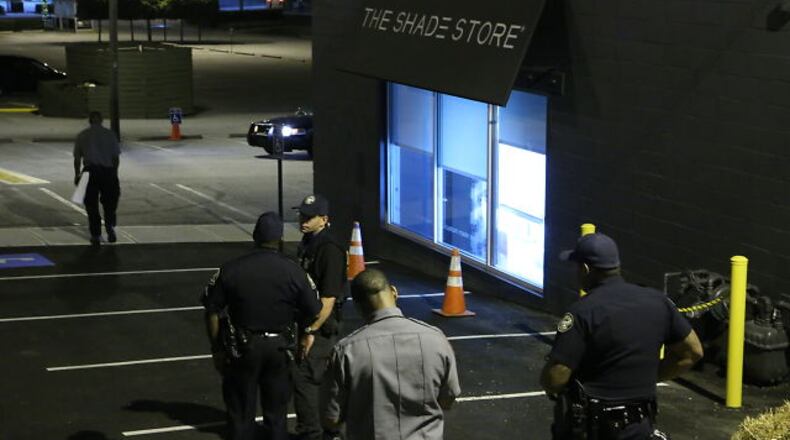 Atlanta police investigate a burglary early Friday at The Shade Store on Howell Mill Road. JOHN SPINK / JSPINK@AJC.COM