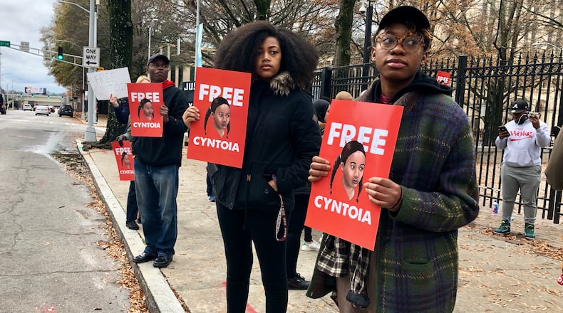 Spelman College student Eva Dickerson (right) and Atlanta resident Jill Cartwright (center) hold signs in support of a clemency push for Tennessee inmate Cyntoia Brown outside the Georgia Capitol on Saturday, Dec. 15, 2018, in downtown Atlanta. Legal activists are urging Tennessee Gov. Bill Haslam to grant Brown’s clemency petition in a case that’s gained international attention. J. SCOTT TRUBEY/STRUBEY@AJC.COM