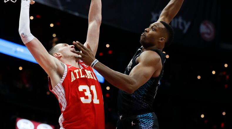 Dwight Howard loads up for an extra large dunk, and there's nothing the Hawks Mike Muscala can do about it.  (AP Photo/John Bazemore)
