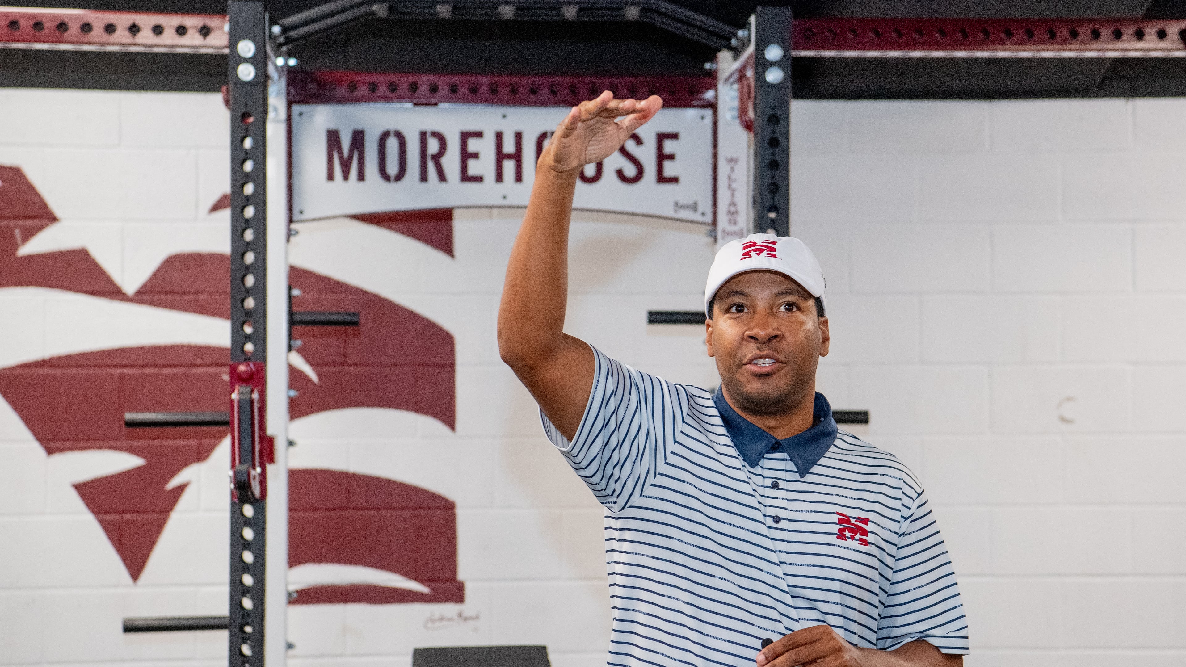 Morehouse golf coach Edgar Evans addresses supporters in the new weight room. ( Kate Awtrey-King for the AJC)