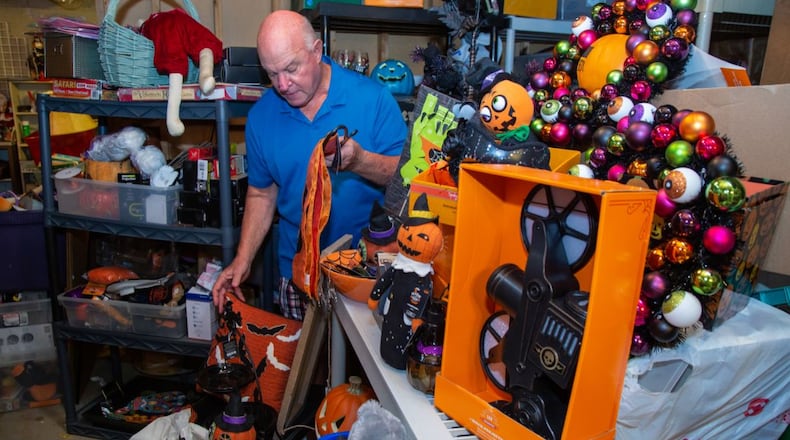 George Wieder, of Tucker, gathers Halloween items to make a gift basket for a charity's silent auction. He is a senior who spends all day every day serving metro Atlantans in many volunteer capacities.(Photo by Phil Skinner)