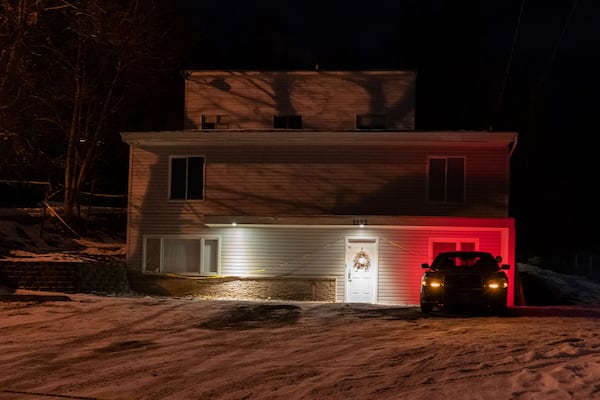 FILE - A private security officer sits in a vehicle on Jan. 3, 2023, in front of the house in Moscow, Idaho where four University of Idaho students were killed in November, 2022. (AP Photo/Ted S. Warren, File)
