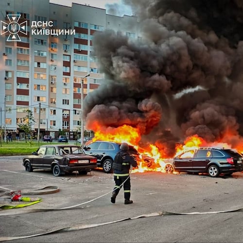 In this photo provided by the Ukrainian Emergency Service, cars burn as firefighters try to put out a fire following a Russian drone attack in Kyiv region, Ukraine, Friday, Aug. 28, 2026. (Ukrainian Emergency Service via AP)