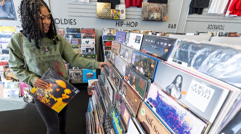 Quashma Price shops for holiday presents at DBS Sounds in Riverdale on Tuesday, Dec. 19, 2023. (Steve Schaefer/steve.schaefer@ajc.com)
