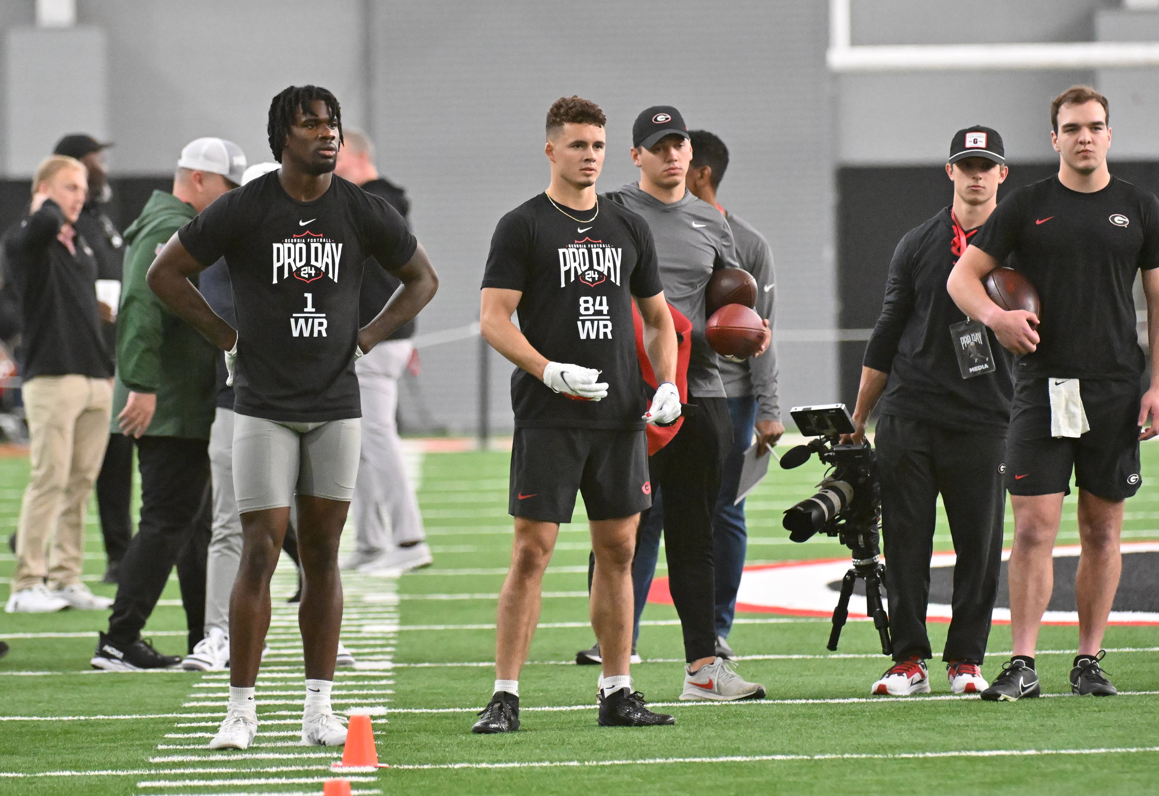Georgia quarterback Gunner Stockton (far right) threw to former UGA wide receiver Marcus Rosemy-Jacksaint (left) and Ladd McConkey during Georgia Pro Day at Payne Indoor Athletic Facility, Wednesday, Mar. 13, 2024, in Athens. (Hyosub Shin/AJC)