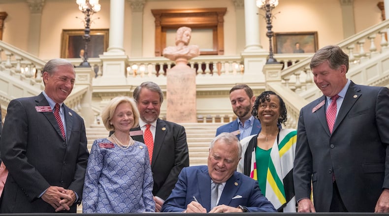 Gov. Nathan Deal signs the 2019 fiscal year state budget at the Georgia state Capitol. Deal has made it a priority while governor to build up the state’s reserves, which are now estimated at $2.5 billion, to guard against an economic downturn. ALYSSA POINTER/ALYSSA.POINTER@AJC.COM