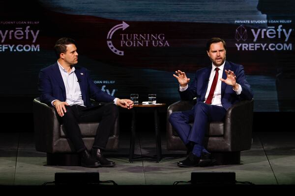 Vice President JD Vance, alongside Turning Point USA spokesperson Andrew Kolvet (left), speaks during a Turning Point USA event at Akins Ford Arena in Athens, Ga., on April 14, 2026. (Arvin Temkar/AJC)