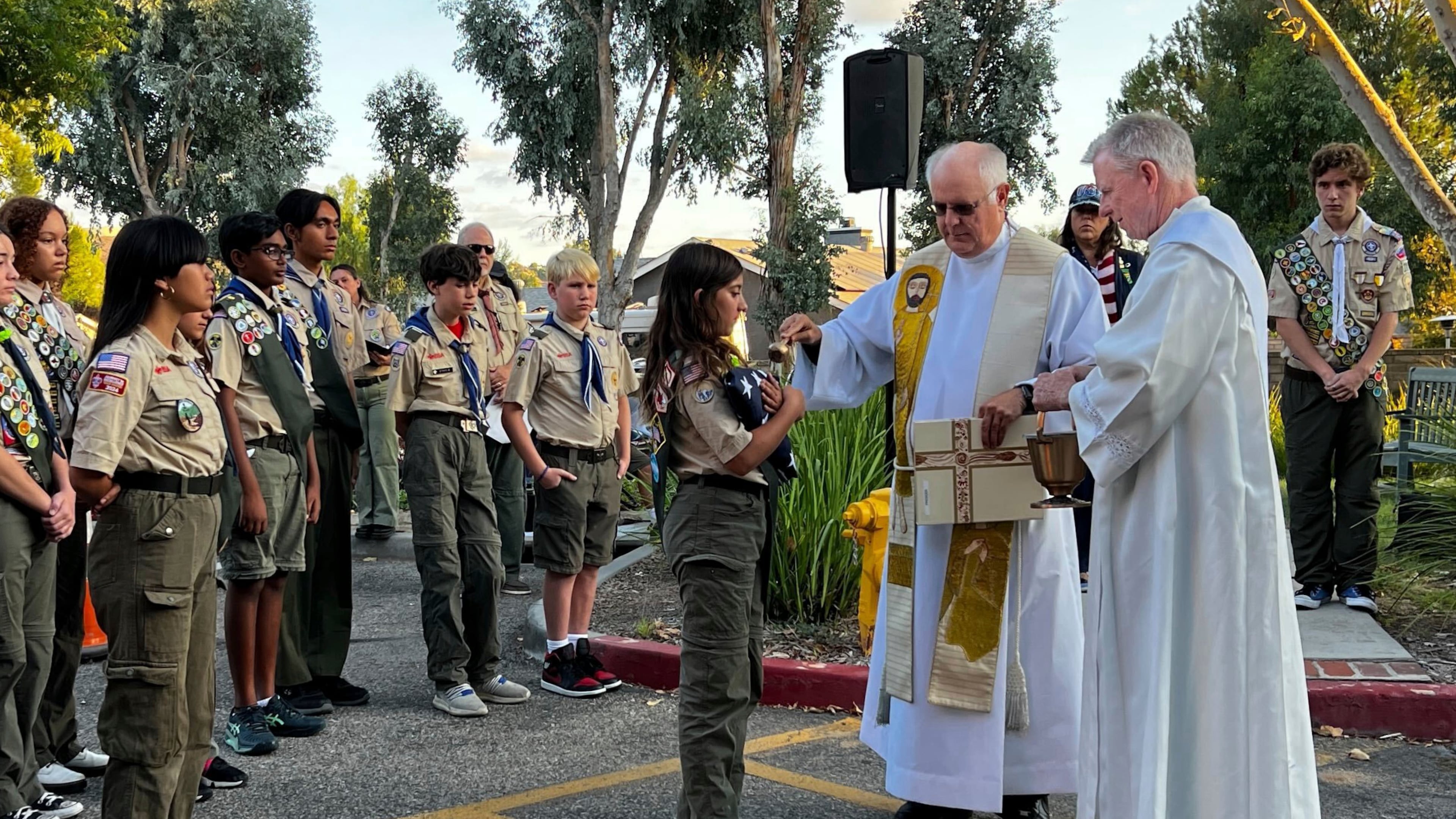 Scout Troop 228 participates in the U.S. flag retirement ceremony for Saint Kateri Tekakwitha Church during the annual Patriots Day observance at the church in Santa Clarita, Calif., on Thursday, Sept. 11, 2025. (AP Photo/Krysta Fauria)