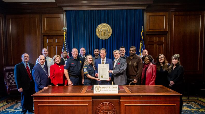 Gov. Brian Kemp recognized Cobb firefighters, two residents and an ambulance service for saving the life of a man who went into cardiac arrest.