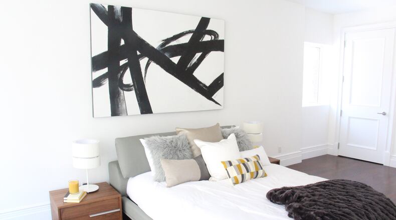 Low, sleek furniture helps maximize space in this second bedroom. (Design Recipes)