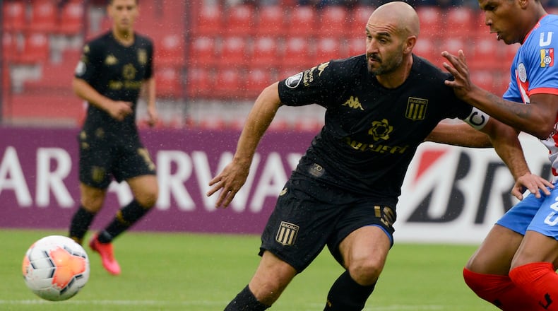 Lisandro Lopez of Argentina's Racing Club, left, and Edison Penilla of Venezuela's Estudiantes de Merida battle for the ball during a Copa Libertadores soccer match March 5, 2020, in Merida, Venezuela. (Matias Delacroix/AP)
