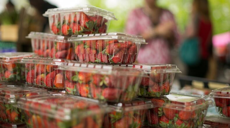 Organic strawberries from Watsonia Farms, of Monetta, South Carolina, are shown for purchase during the Johns Creek farmers market at the Newtown Park Amphitheater in April 2015.