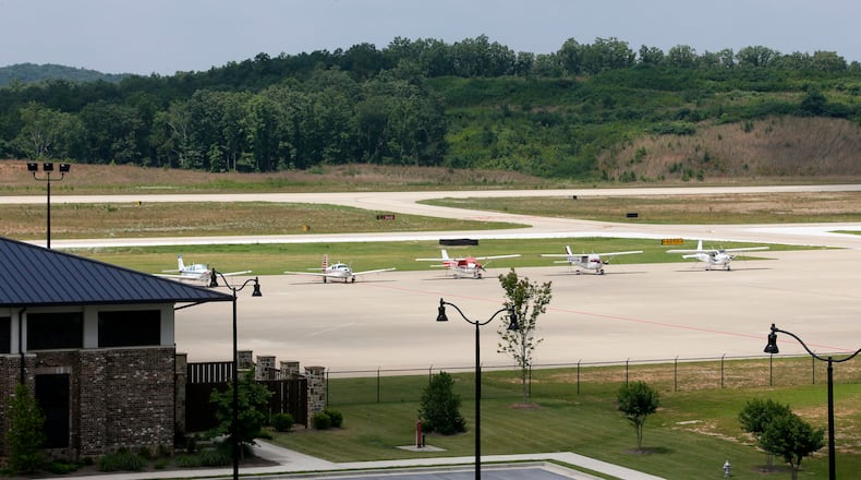 June 25, 2014 - Paulding County - Planes are parked on the tarmac are in an area that is planned for jet operations. New hangers are under construction. The expanded taxiway is visible behind them. The terminal is at left. Taxi way expansion has been completed, and construction continues in FBO area of Paulding County Airport. First, Delta CEO Richard Anderson said he would fight Paulding County's effort to commercialize its airport. Then residents filed four legal challenges. Now, the city of Atlanta is threatening legal action, saying Paulding, which purchased land from Atlanta for the airport back in 2007, is in breach of contract on that deal. Paulding officials deny that and say Atlanta's opposition flies in the face of the regionalism that Mayor Kasim Reed spoke about to leaders there a few years ago. BOB ANDRES / BANDRES@AJC.COM